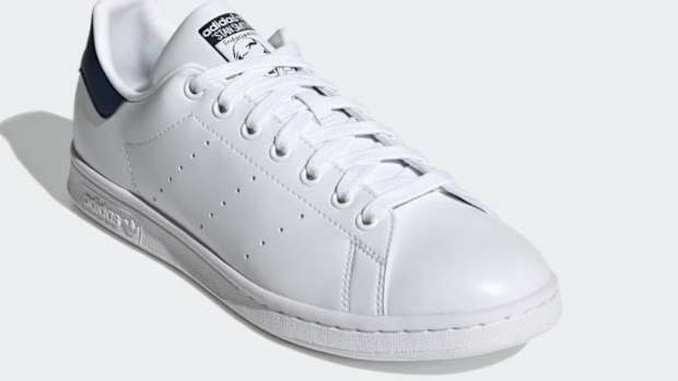 White and navy Adidas shoe.